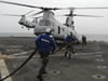 Flight deck crew rush to refuel helo